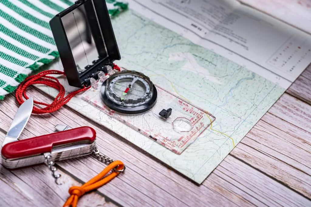 Topographic map, baseplate compass and handheld GPS unit laid out together
