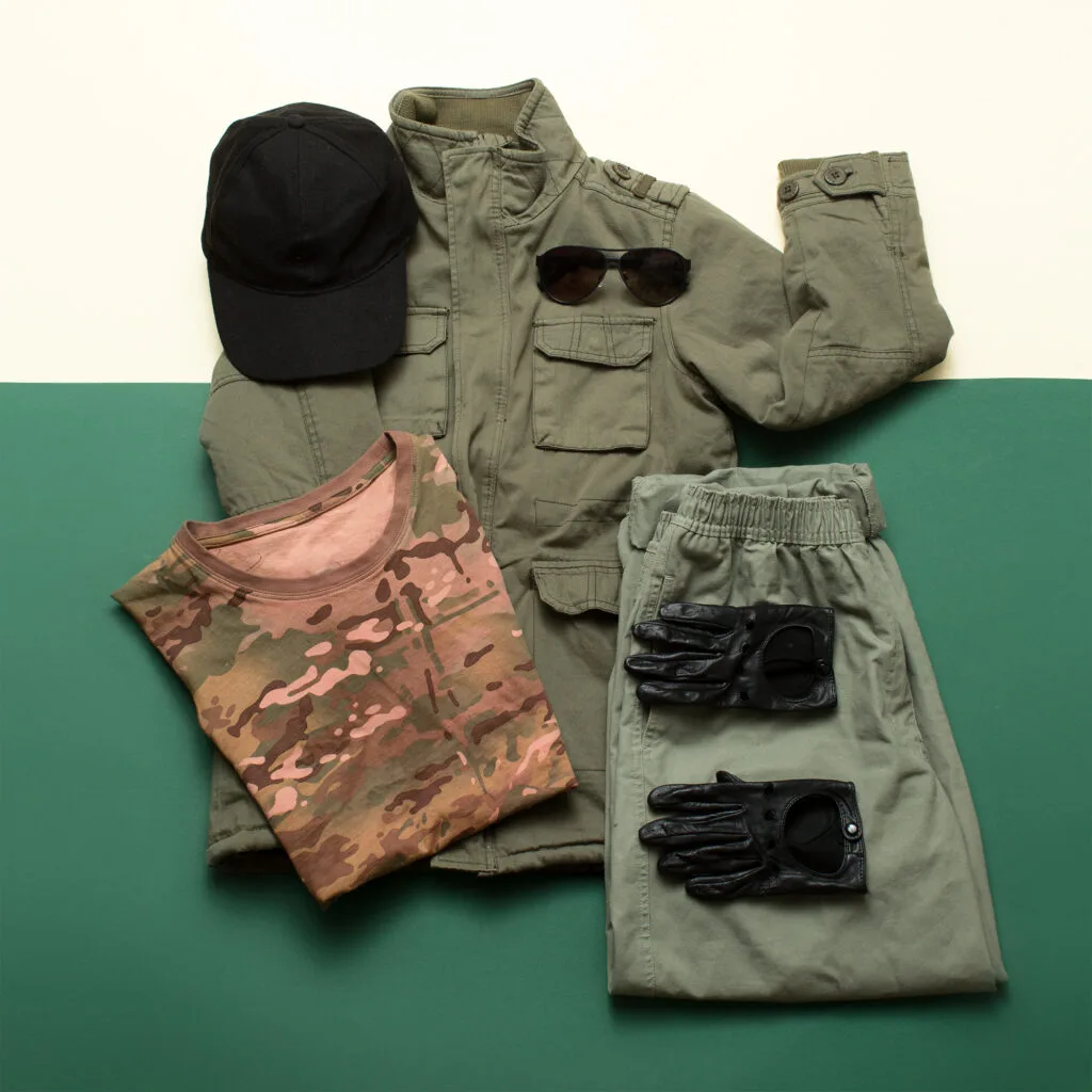 Layered field clothing set laid out flat, base layer through outer shell