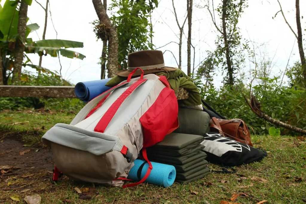 Image of an overstuffed backpack, bulging and spilling gear.