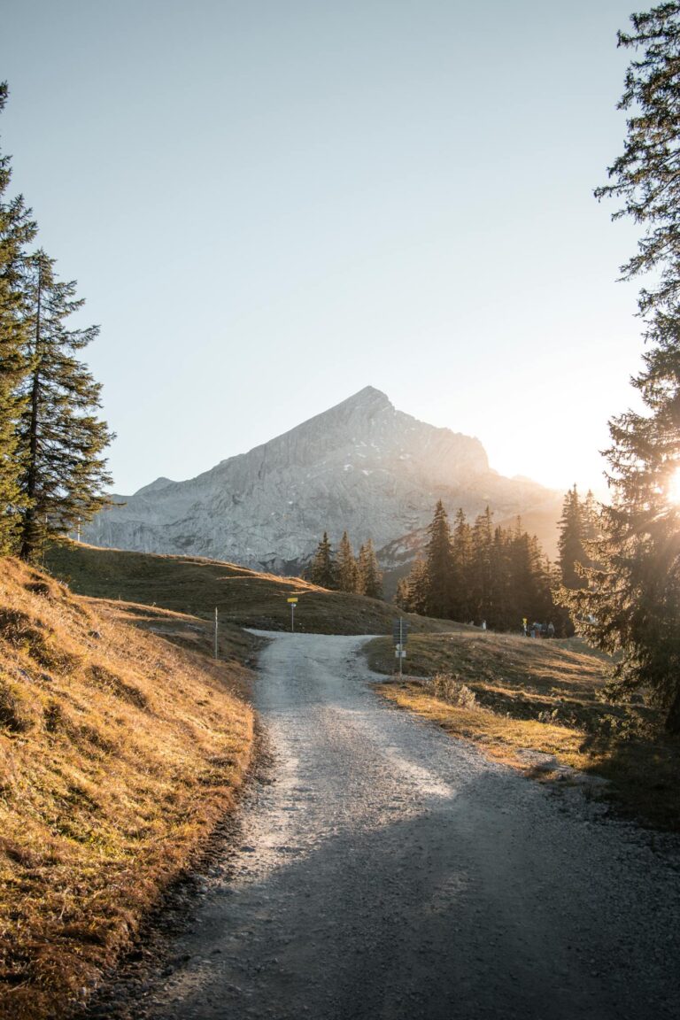 Explore the serene mountain pathway in Garmisch-Partenkirchen, Bavaria, with stunning sunrise views.