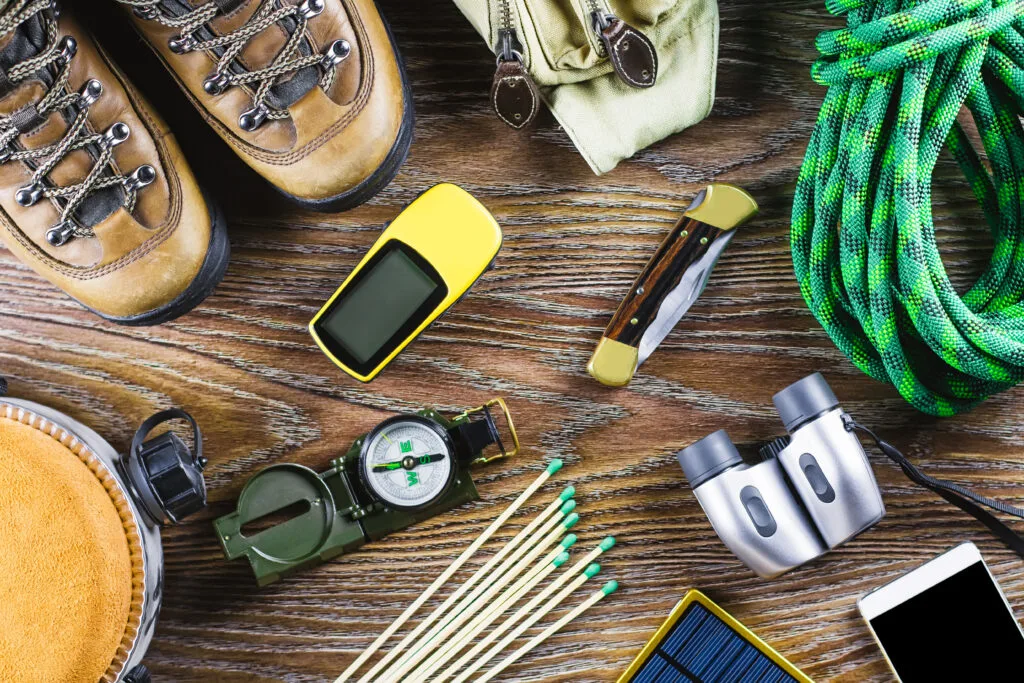 Hiking gear laid out flat on a wooden desk for a shakedown check