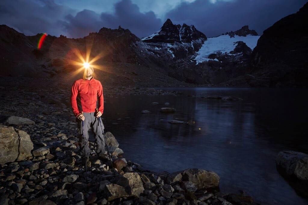 Night navigation, Hiker with headlamp standing at Lago de los Tres, Los Glaciares National Park, Patagonia, Argentina