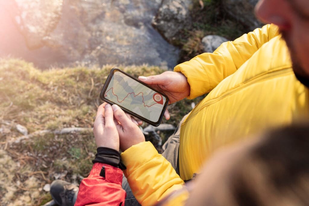 Smartphone with offline hiking map app in use