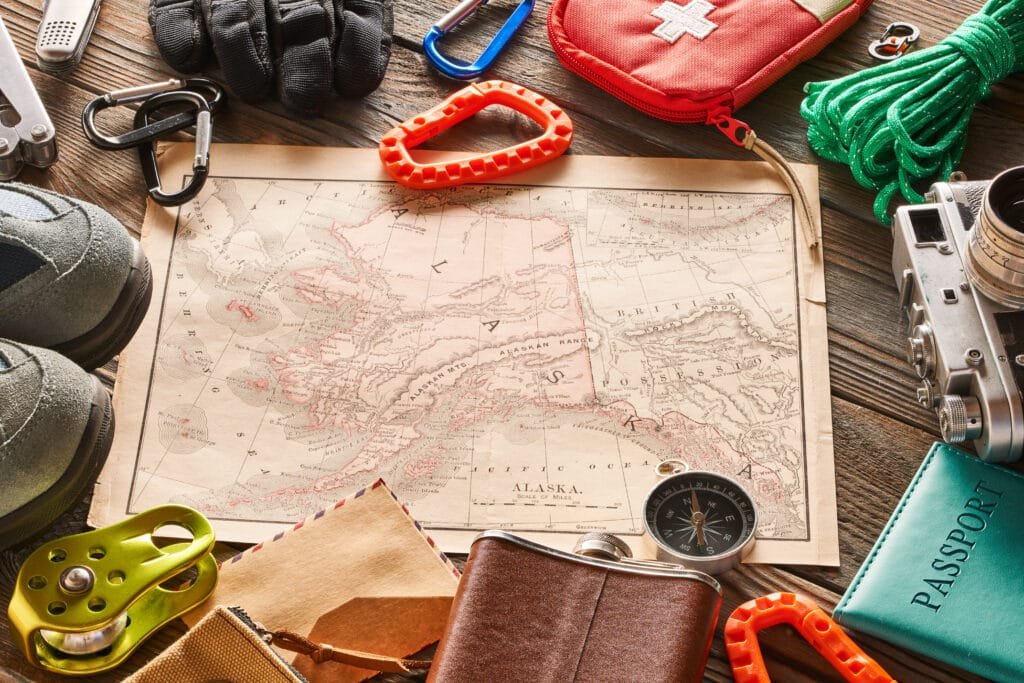 Travel items for hiking tourism still life over wooden background