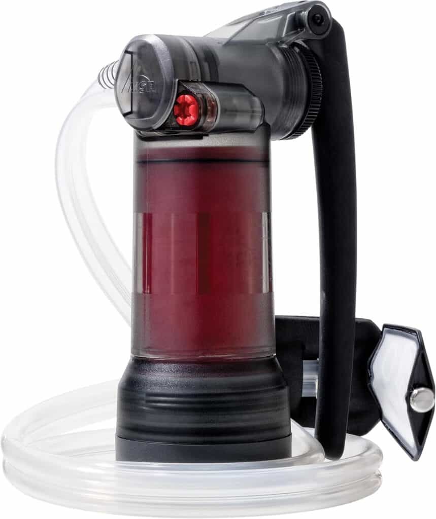Portable vacuum pump with transparent red fluid container, black handle, and tubing for outdoor adventure and repair projects.