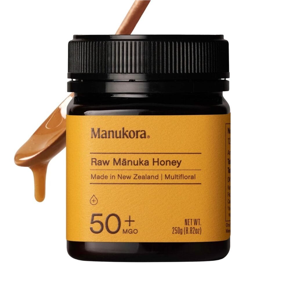 Manukora Raw Manuka Honey in a black jar with a yellow label, featuring health benefits and natural ingredients, ideal for promoting wellness, immunity, and natural remedies.