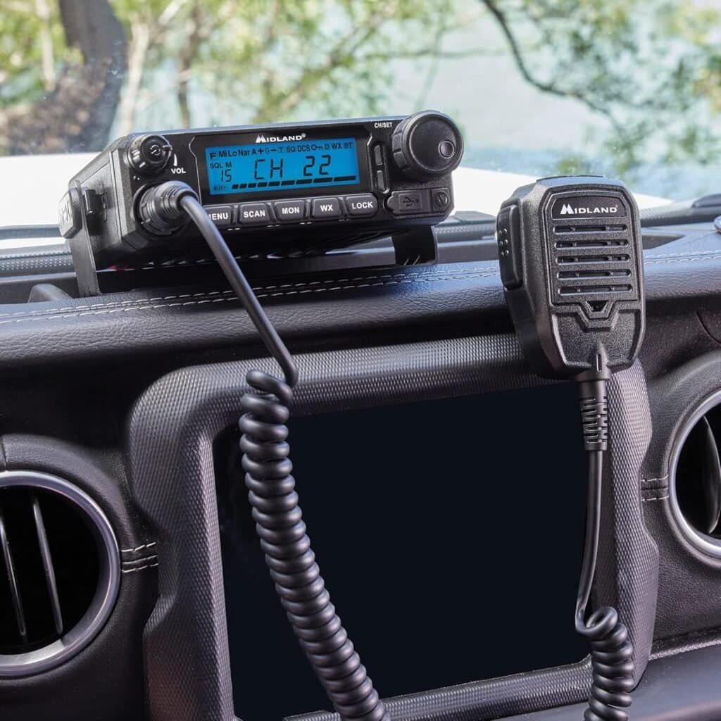 Handheld CB radio mounted inside a vehicle for outdoor communication and adventure trips.