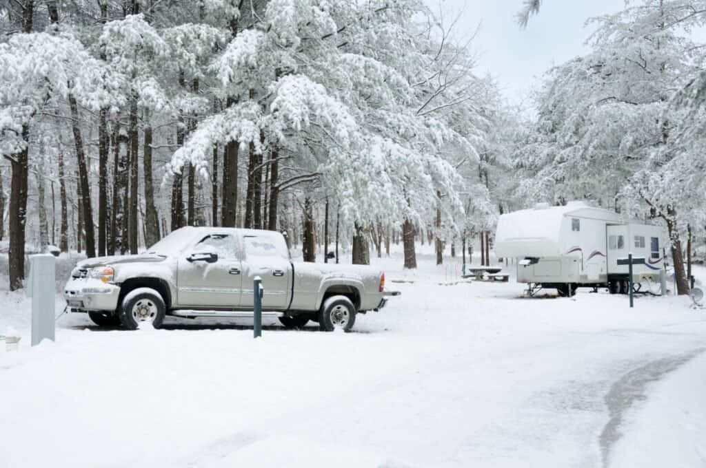 Snowy campsite with truck and trailer